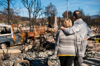 A couple checking ruins after a fire disaster