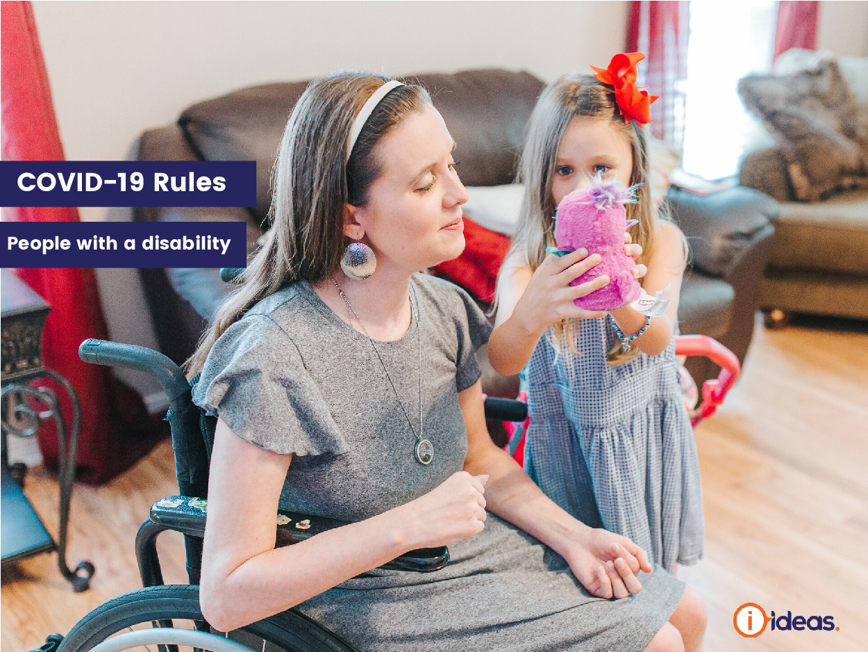 Woman in a wheelchair being shown a toy by her child