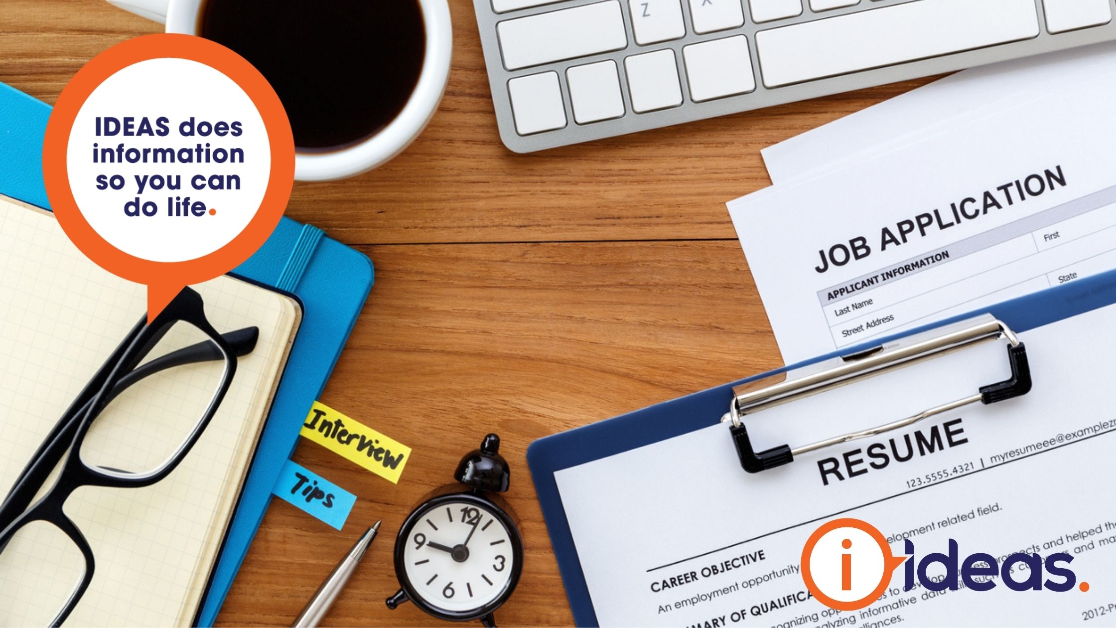 Job application and résumé froms on a desk with reading glasses, folder, keyboard and coffee