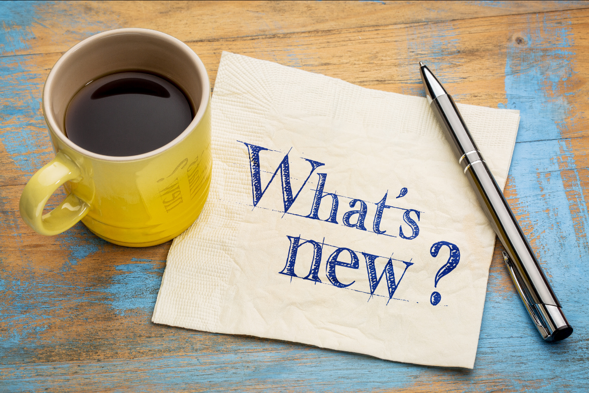Image of coffee cup with paper next to it and text saying What's new?