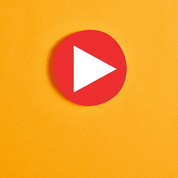 Image of large red video play button on orange background.