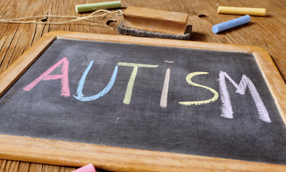 Image of a chalkboard with the work "autism" written on it.