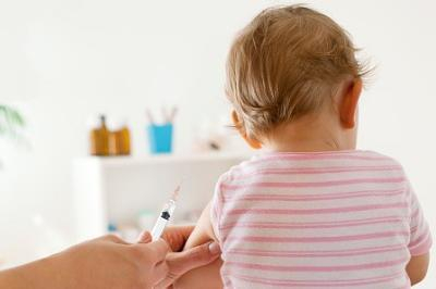 baby girl about to receive an vaccination injection