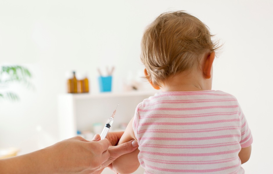 baby girl about to receive a vaccination 