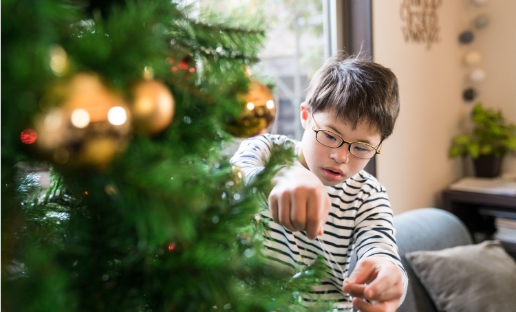 Boy decorates tree