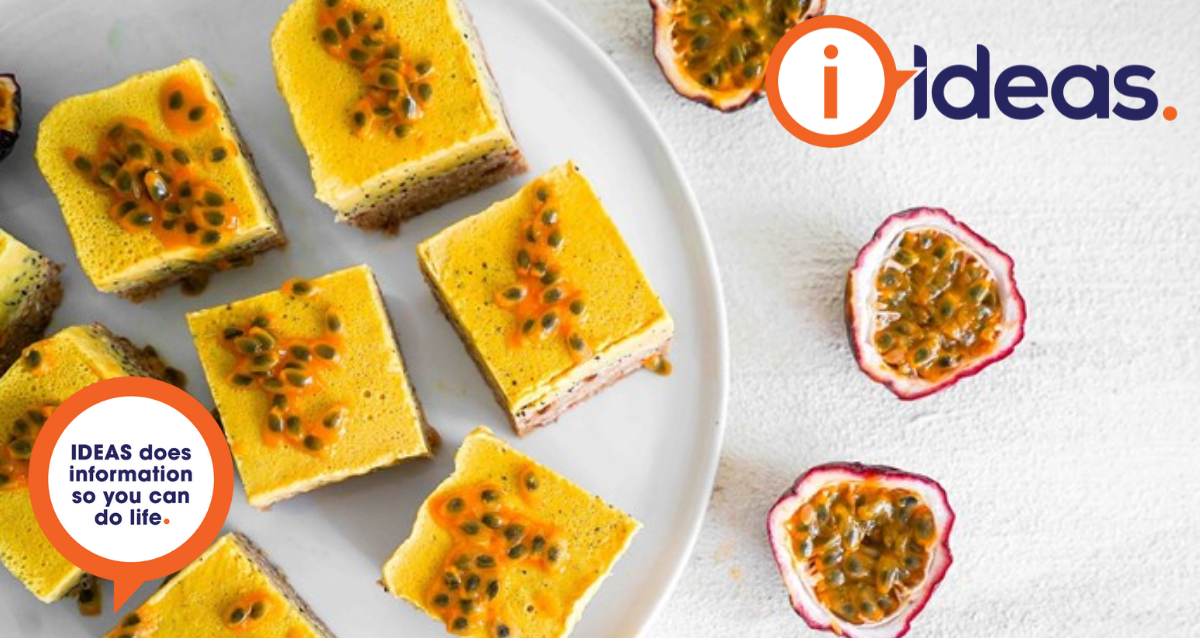 passionfruit slice on a white flat lay with passionfruit in right hand corner
