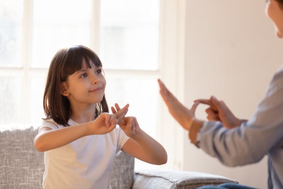 young girl and woman using sign language to communicate