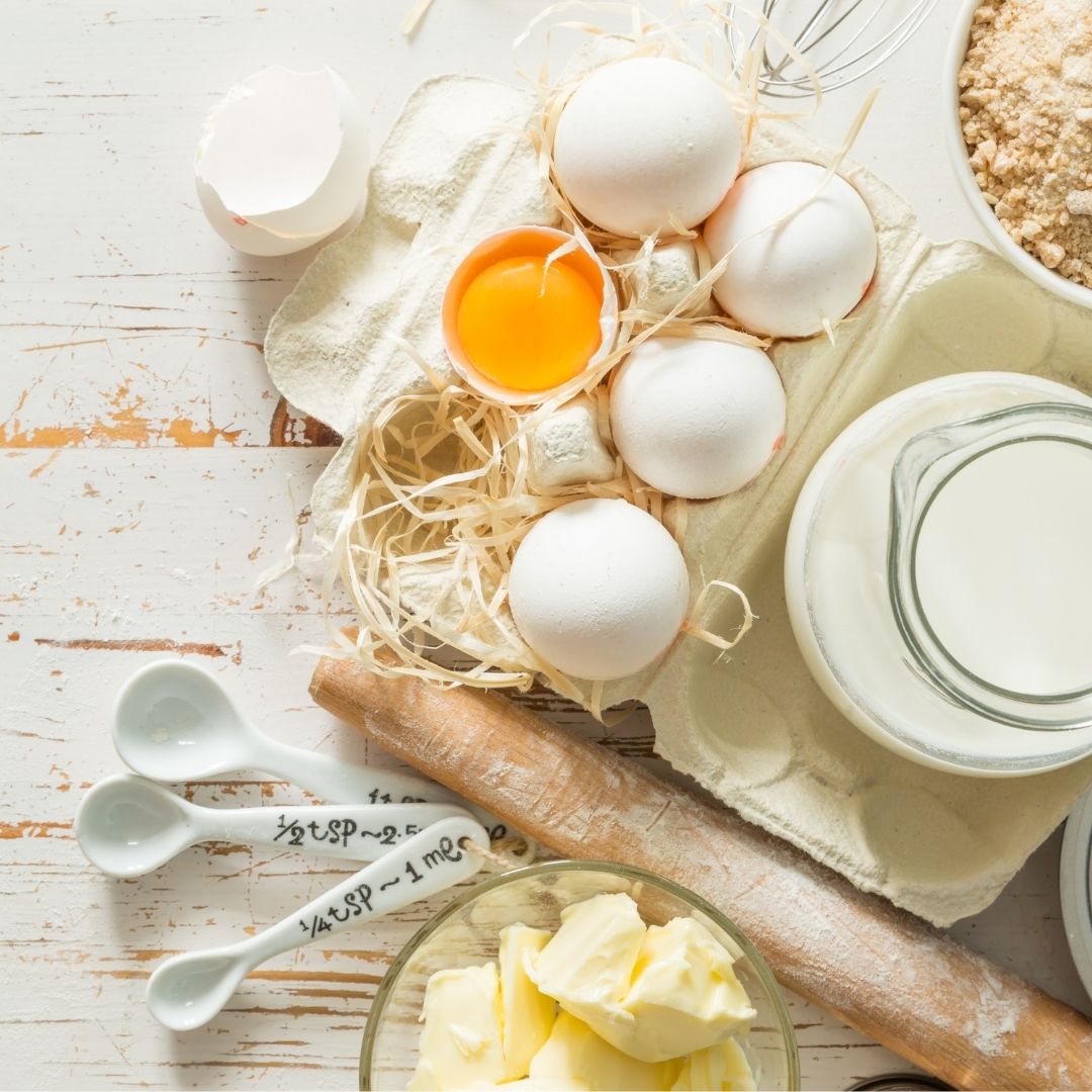 baking ingredients and utensils. eggs, flour, measuring spoons