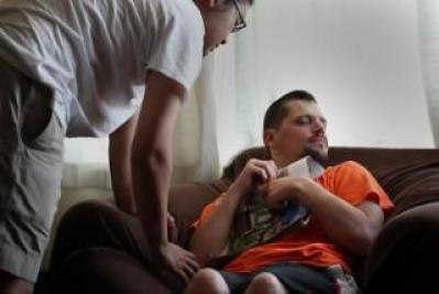 Image of a man sitting on a couch