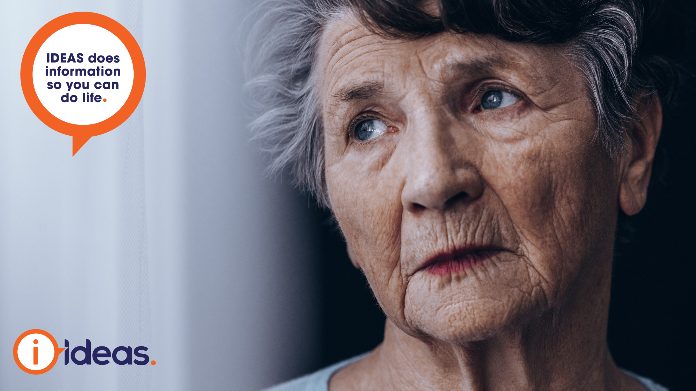 Old woman looking solemnly through a pane of glass