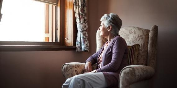 Elderly woman looking out a window