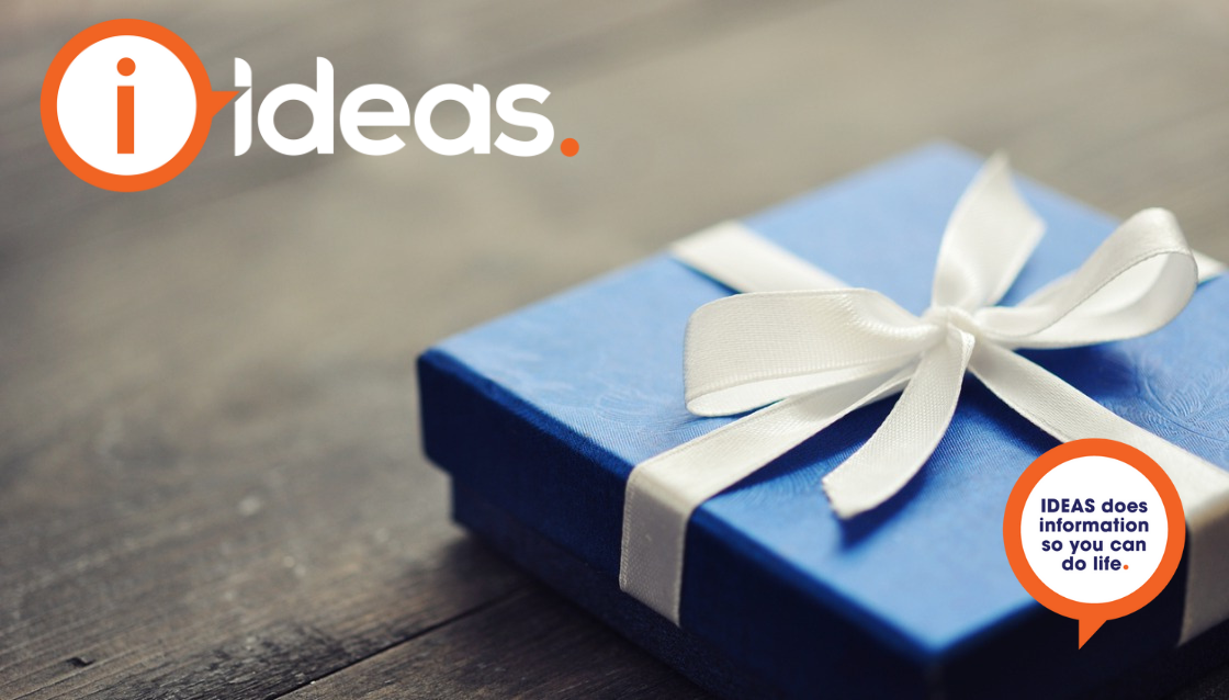 A blue giftbox with white ribbon sits on a wooden background.