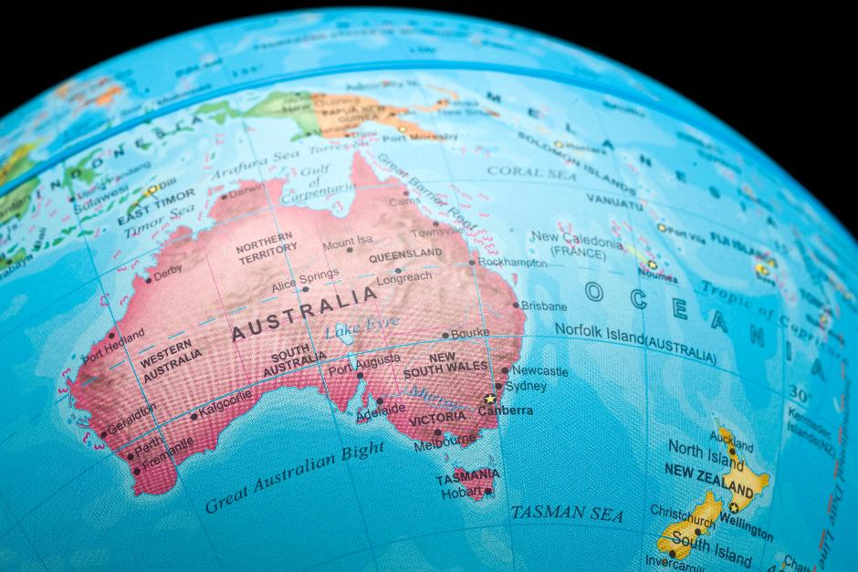 An image of a portion of a world globe showing a map of Australia in Pink