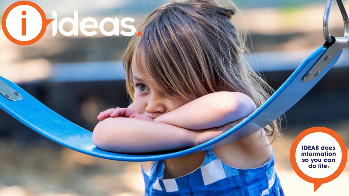 A young girl leaning on a swing