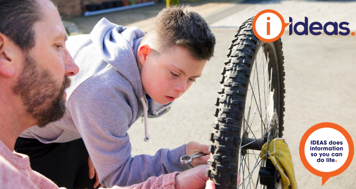 A boy with disability learns how to repair a bicycle