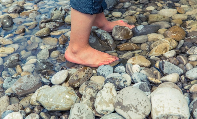 Barefoot child in water