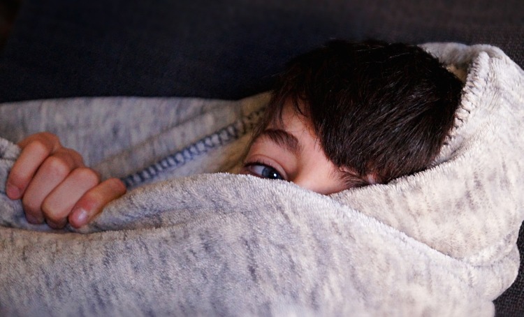 Boy inside blanket