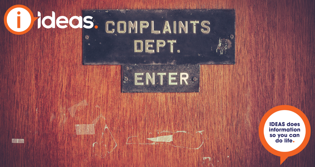 A close up of a door, with the words "Complains Dept, Enter"
