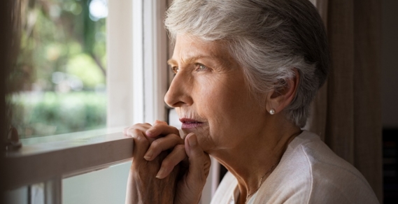 Elderly lady looking out a window