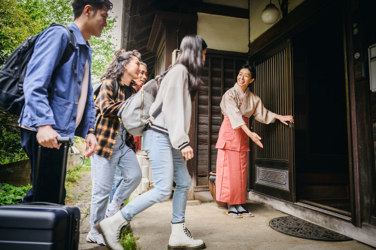 Image of visitors being welcomed to a Japanese Inn