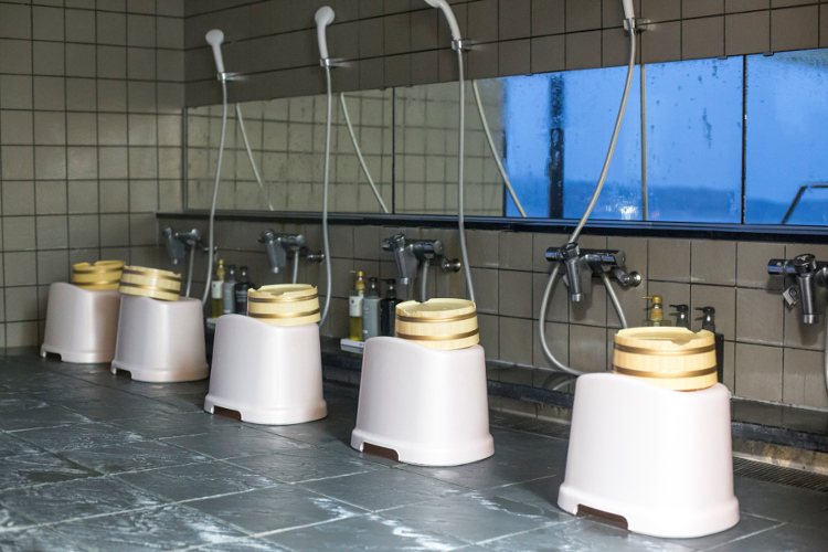 Japanese Onsen with small stool and handheld showerhead.