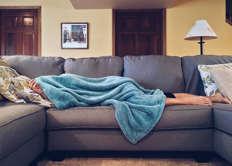 Sick person under blanket