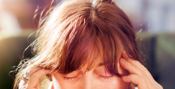 Close up of a woman rubbing her temples