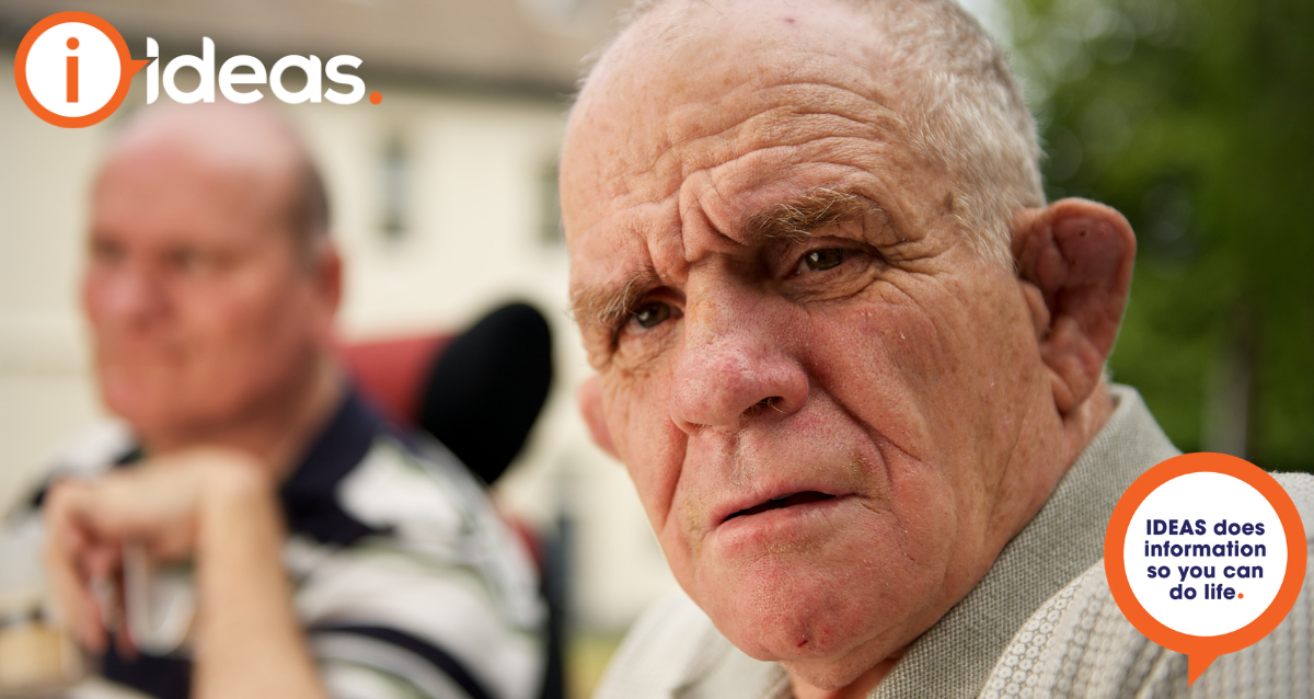 A man with intellectual disability looks toward the camera