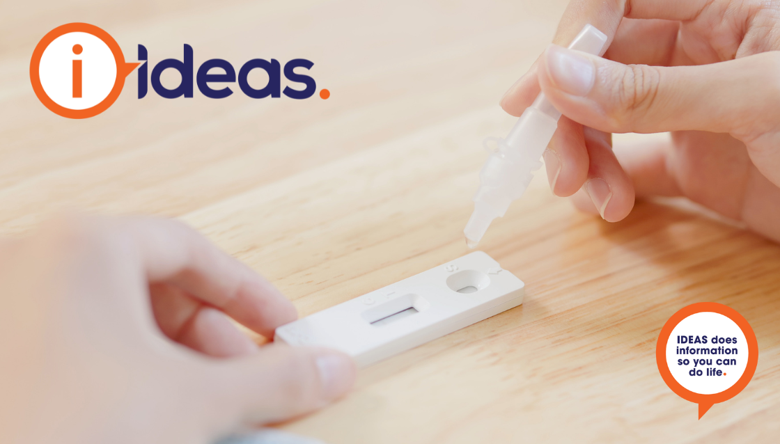 A RAT test, a person is holding the cartridge and dropping the test vial into the cartridge