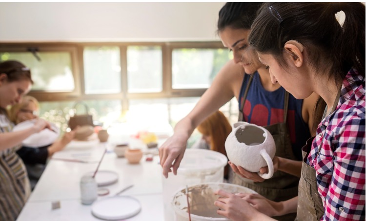 Girl with disability making pottery