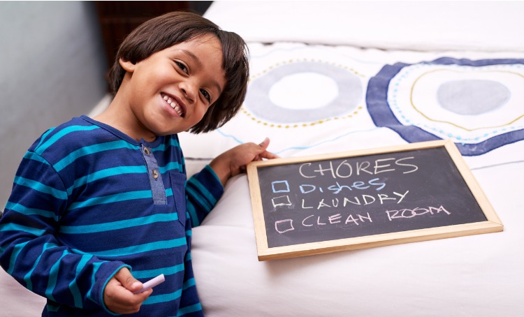 A young boy has a blackboard with three chores