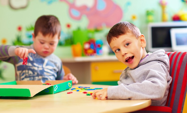 Two young boys with disability at playgroup