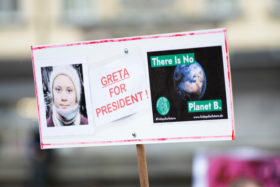 Image of placcard with picture of Greta Thunberg's face, words "Greta for President" and image of the world with words "there is no Planet B"