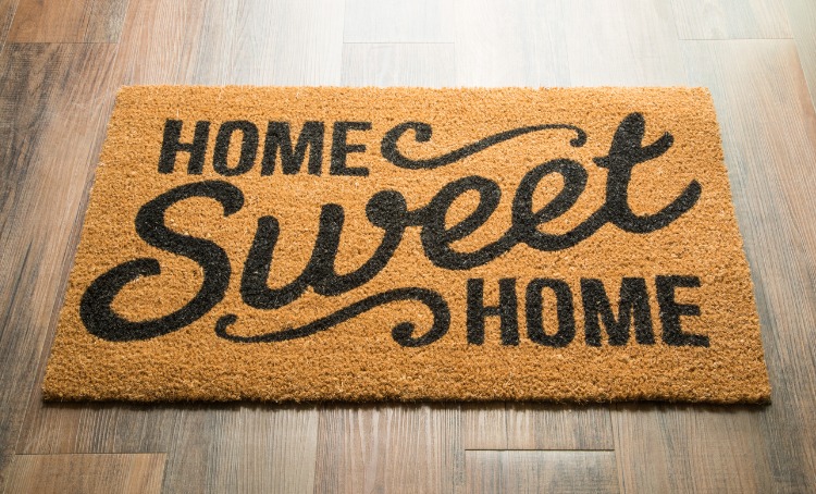 home sweet home welcome mat on floor 