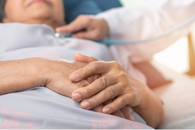 elderly woman in a hospital bed having a medical exam