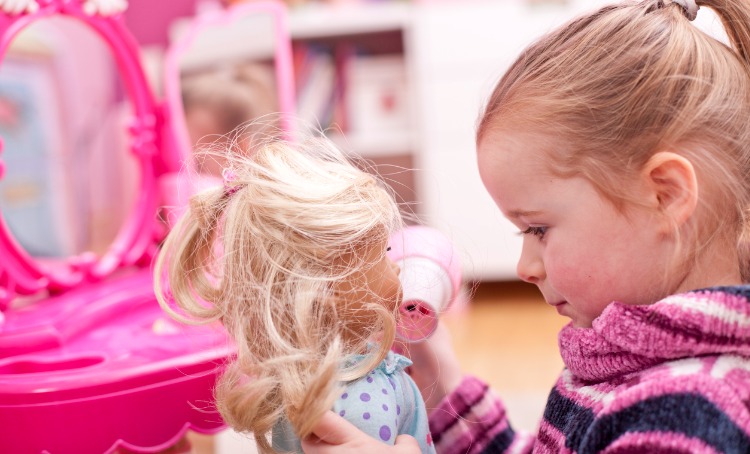 little girl is playing with her doll picture 