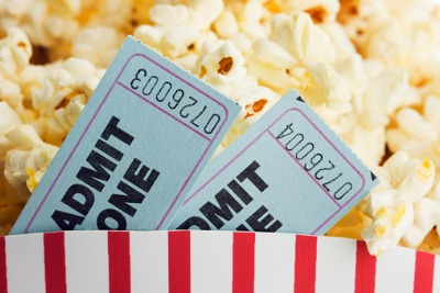 Image of popcorn and two movie tickets