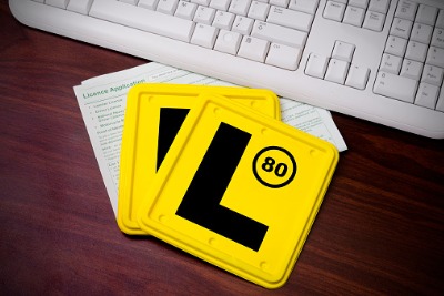 Two yellow "L" learner plates