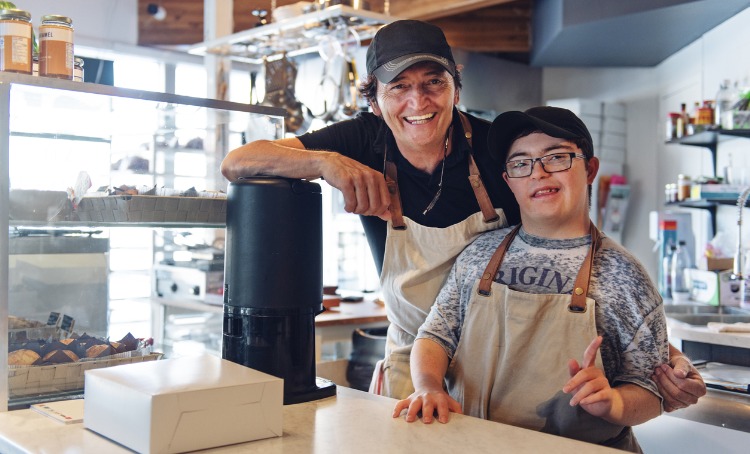 Teen boy with cerebral palsy in the workplace with his supervisor