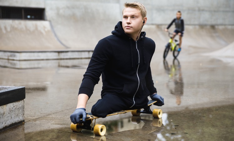 teen with a disability riding a skateboard