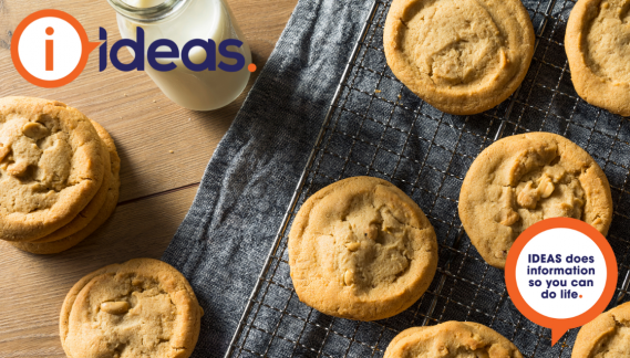 Cookies and a glass of milk laid on a cooling tray.