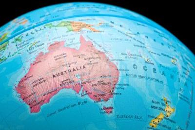 An image of a portion of a world globe showing a map of Australia in Pink