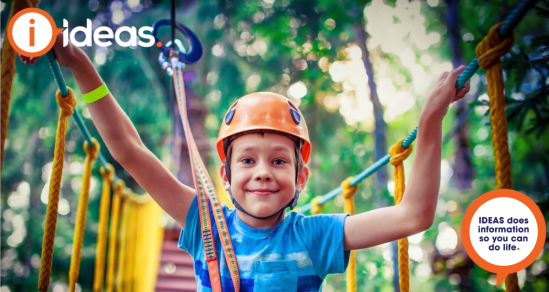 Image of boy wearing helmet on rope course