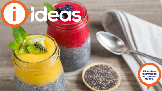 Two chia puddings, one with mango smoothie and mint, the other with berry smoothie and blueberry.