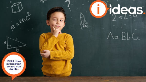 A young boy with a stance of thinking, stands in front of a blackboard. On the blackboard are designs with a concept of creating ideas.