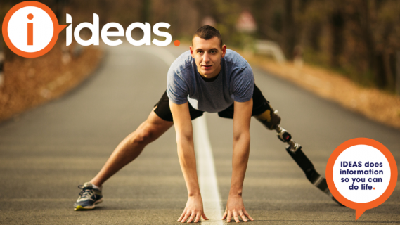 A young man reaches his arms down to the road, his legs are wide  as he stretches before a run. He has a prosthetic leg.