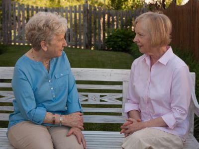 Two female neighbours sitting and chatting