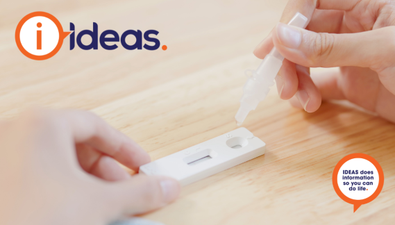A RAT test, a person is holding the cartridge and dropping the test vial into the cartridge