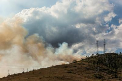 Image of bushfire smoke with power lines on the hill