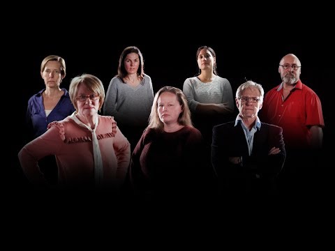 Group of people standing in a dark room